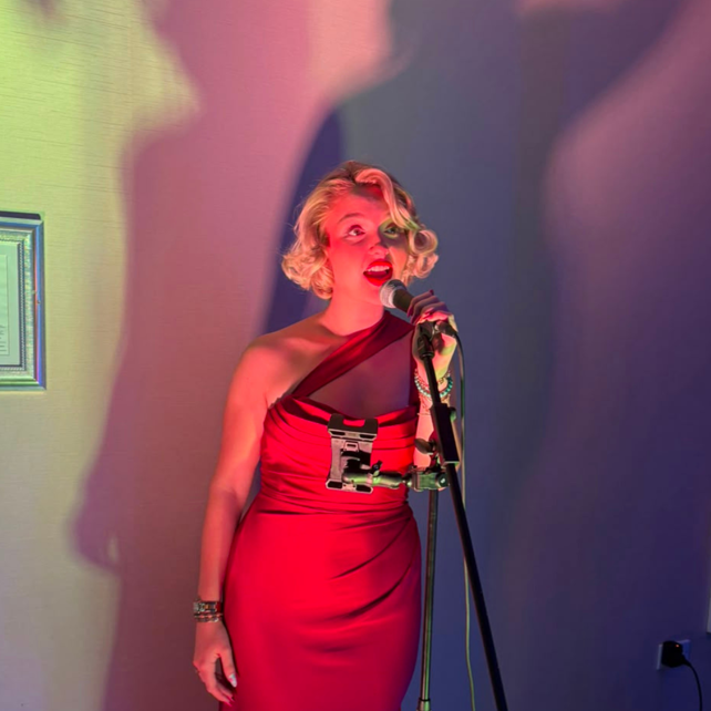 Jessica Ormesher sand during the welcome drinks reception at the Headway Sefton Ball